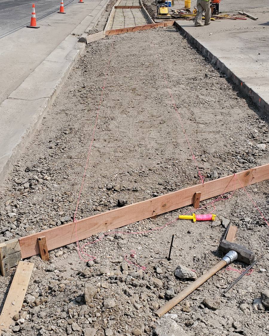 Sidewalk forms and rebar set before a concrete pour